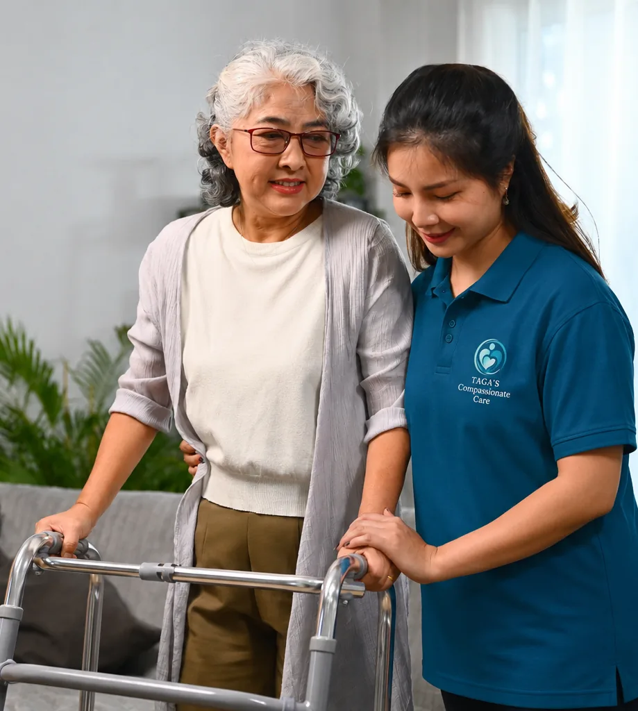 Support worker steadying an older adult on her walker at home